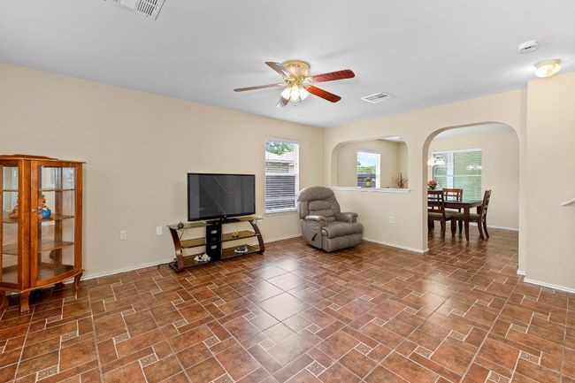 Sitting room featuring ceiling fan and arched walkways | Image 6