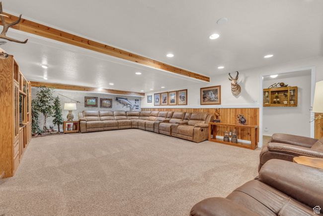 Carpeted living room with recessed lighting, beam ceiling, wainscoting, and wooden walls | Image 21