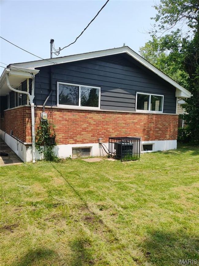 View of home's exterior featuring brick siding and a yard | Image 17