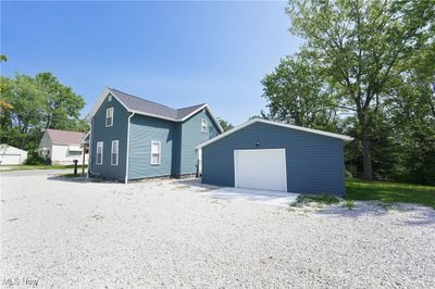 View of side of property featuring a garage and an outdoor structure | Image 3