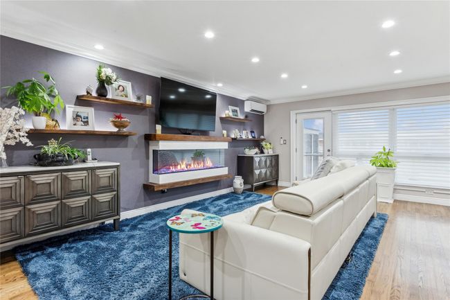 Living room featuring hardwood / wood-style floors, ornamental molding, and a wall mounted air conditioner | Image 8