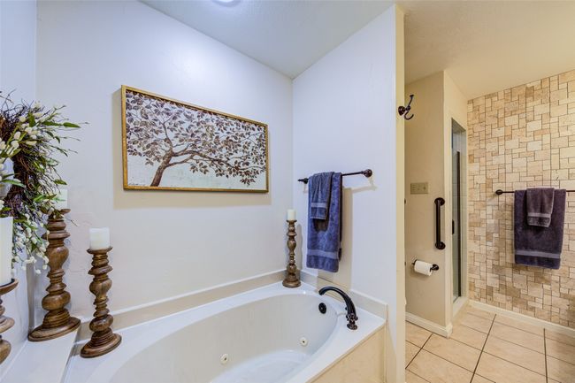 Full bathroom with a whirlpool tub, tile patterned flooring, and a shower stall | Image 21
