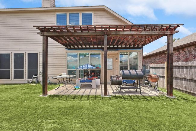 Rear view of house with a pergola, a patio, and a chimney | Image 30