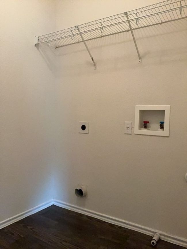 Laundry area featuring dark wood-style flooring, washer hookup, and electric dryer hookup | Image 24