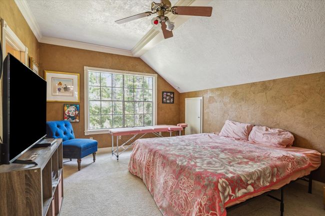 Charming two-story home with a welcoming front porch, nestled among mature trees. Features dormer windows, a classic gable roof, and a spacious yard, perfect for enjoying nature and outdoor activities. | Image 9