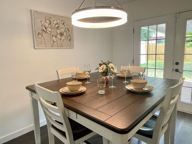 Dining area with french doors, plenty of natural light, and wood finished floors | Image 4