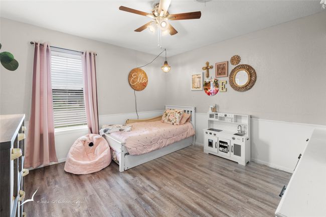 Bedroom with baseboards, a ceiling fan, and wood finished floors | Image 21