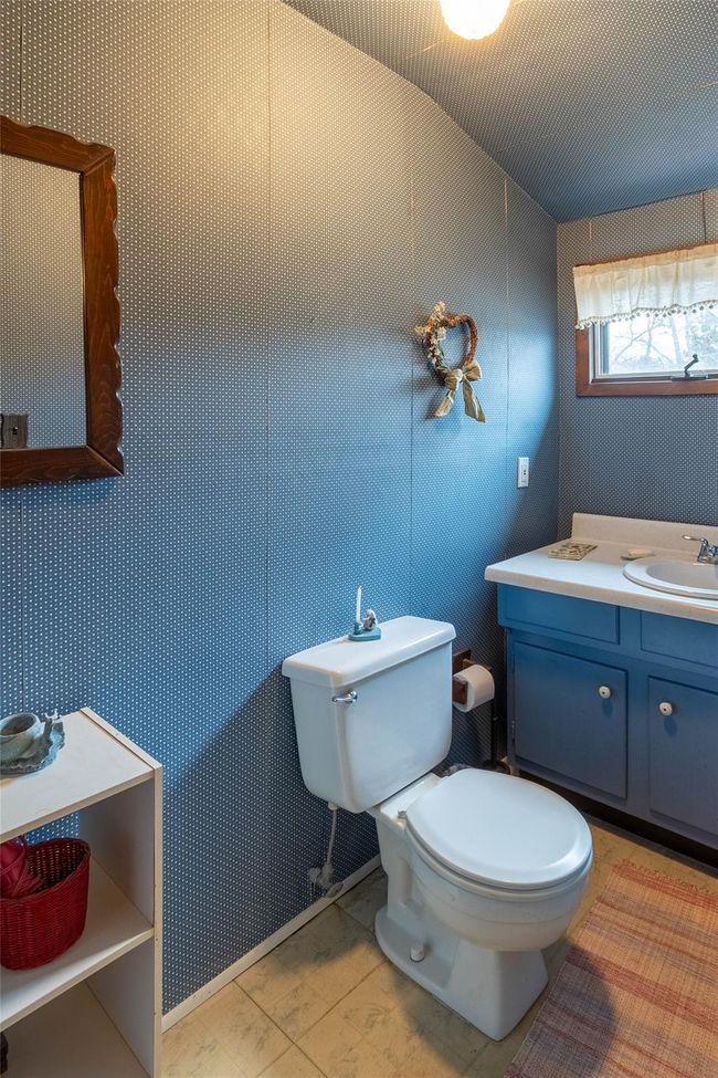 Half bathroom featuring toilet, tile patterned floors, and vanity | Image 20