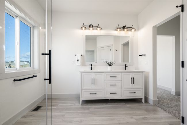 Bathroom with double vanity and wood finished floors | Image 35