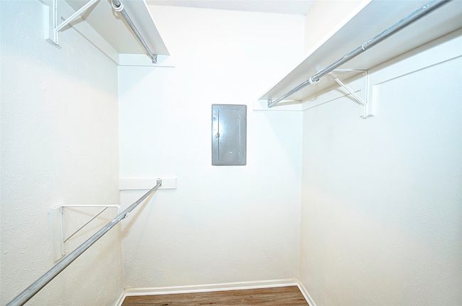 Spacious closet featuring hardwood / wood-style flooring and electric panel | Image 21