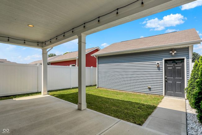 View of backyard, covered patio, fully fenced-in yard for privacy from the alley-load 2-car detached garage. | Image 23