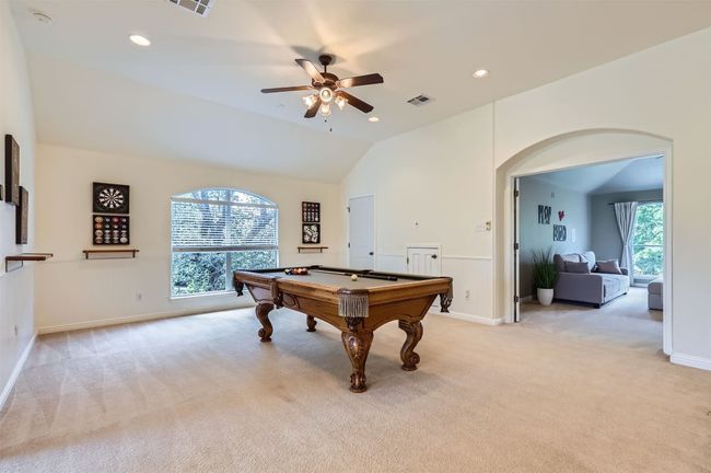 Versatile game room with plenty of space to unwind. | Image 19