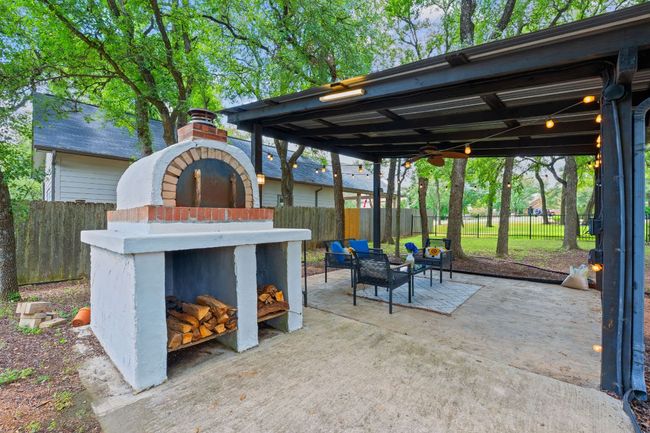 Fenced backyard with a fireplace and a patio | Image 33