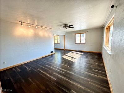 Living room featuring a ceiling fan | Image 2