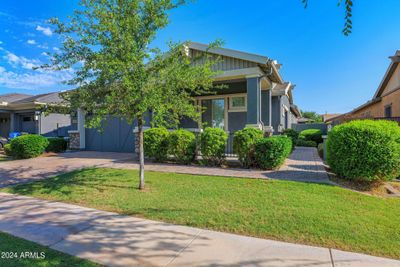 This view shows the walkway to the front door, located on the east side of this south-facing home. | Image 2