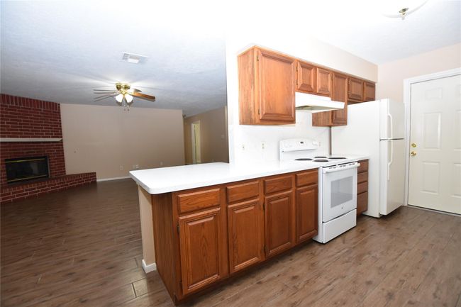 This thoughtfully designed breakfast bar serves as a functional and stylish bridge between the efficient galley kitchen and the inviting living room. | Image 11