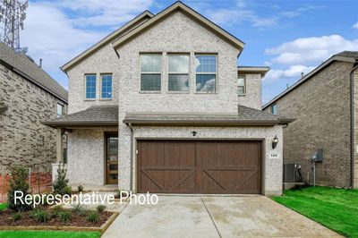 View of front of home featuring central AC unit and a garage | Image 1