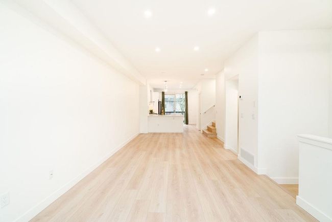 Hall featuring baseboards, stairway, light wood finished floors, and recessed lighting | Image 14
