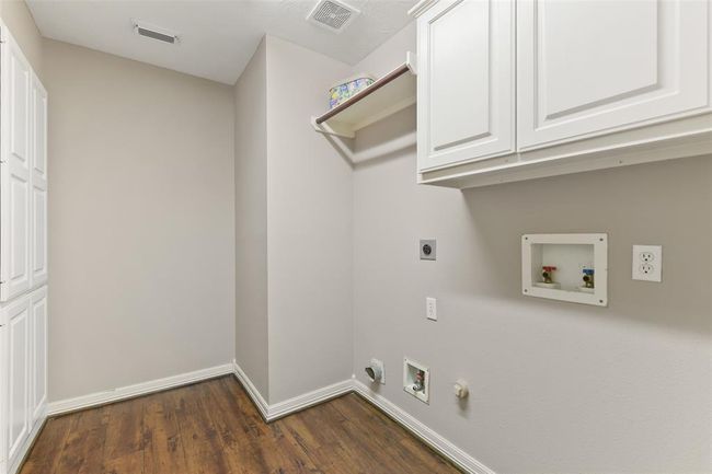 Laundry room has a large amount of storage and this home does have a laundry shoot. | Image 19