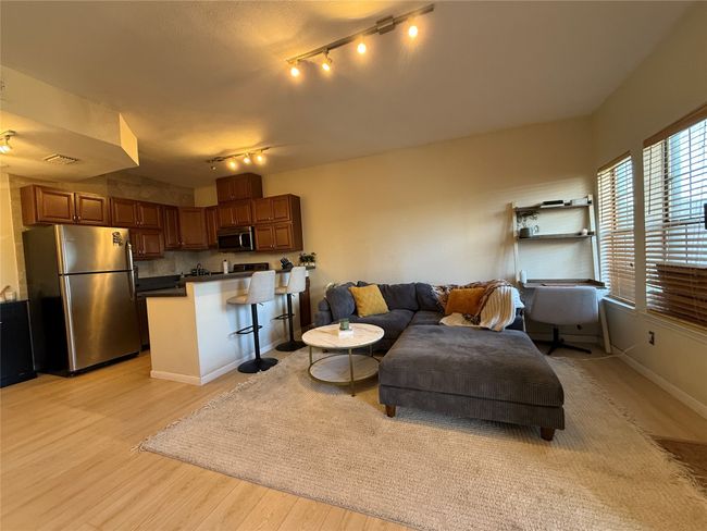 Living room featuring visible vents, light wood-style flooring, and baseboards | Image 25