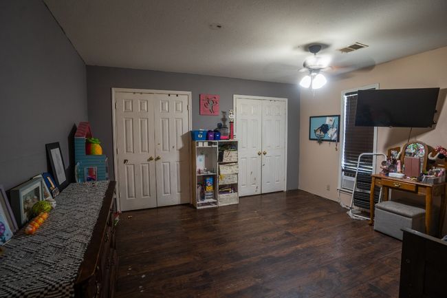 Bedroom with two closets and dark wood-style flooring | Image 13