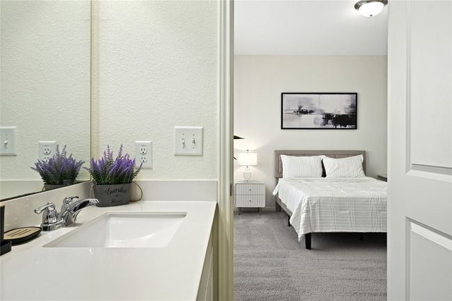 Bedroom featuring a textured wall, a sink, and carpet | Image 27