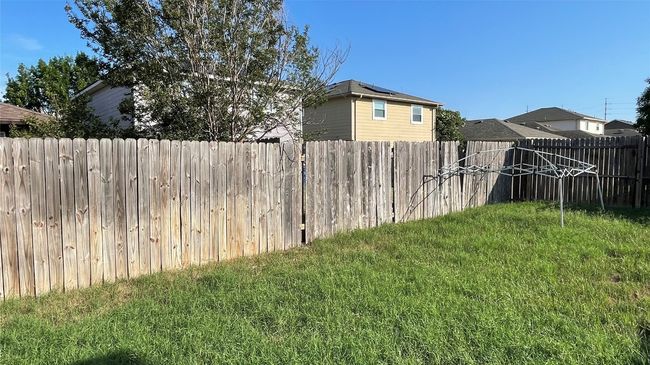View of fenced backyard | Image 22