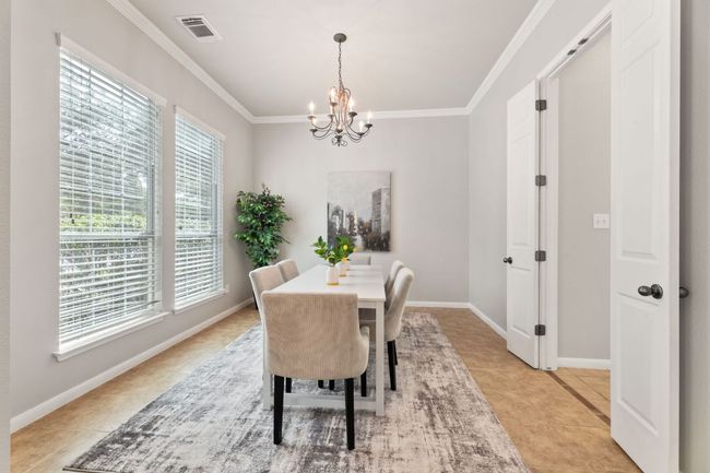 Dining room with a chandelier, ornamental molding, and light tile patterned flooring | Image 8