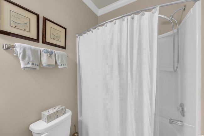 Bathroom featuring ornamental molding and shower / bath combination with curtain | Image 13