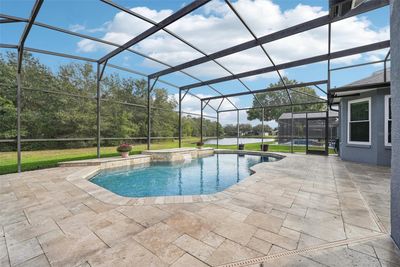 Spacious under screen pool that has PebbleTec surface & a travertine tile pool deck! | Image 3