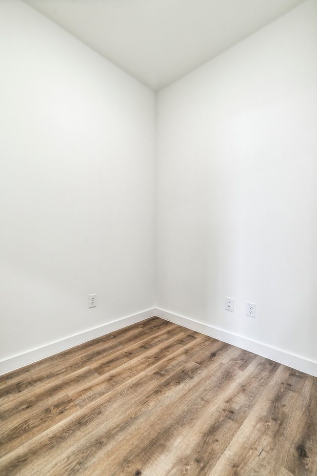 Empty room with baseboards and wood finished floors | Image 24