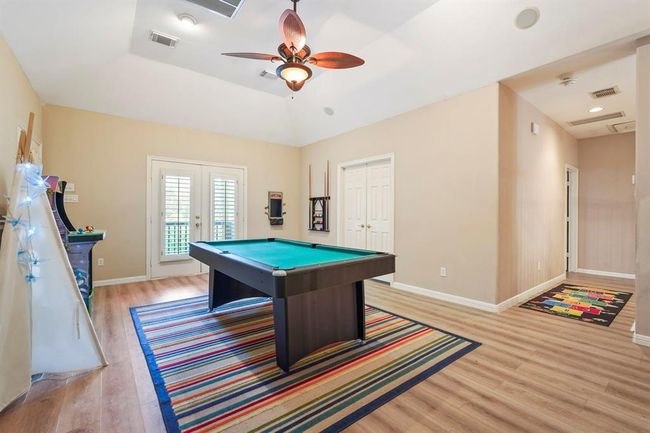 Game room with a door to the Media room. | Image 34