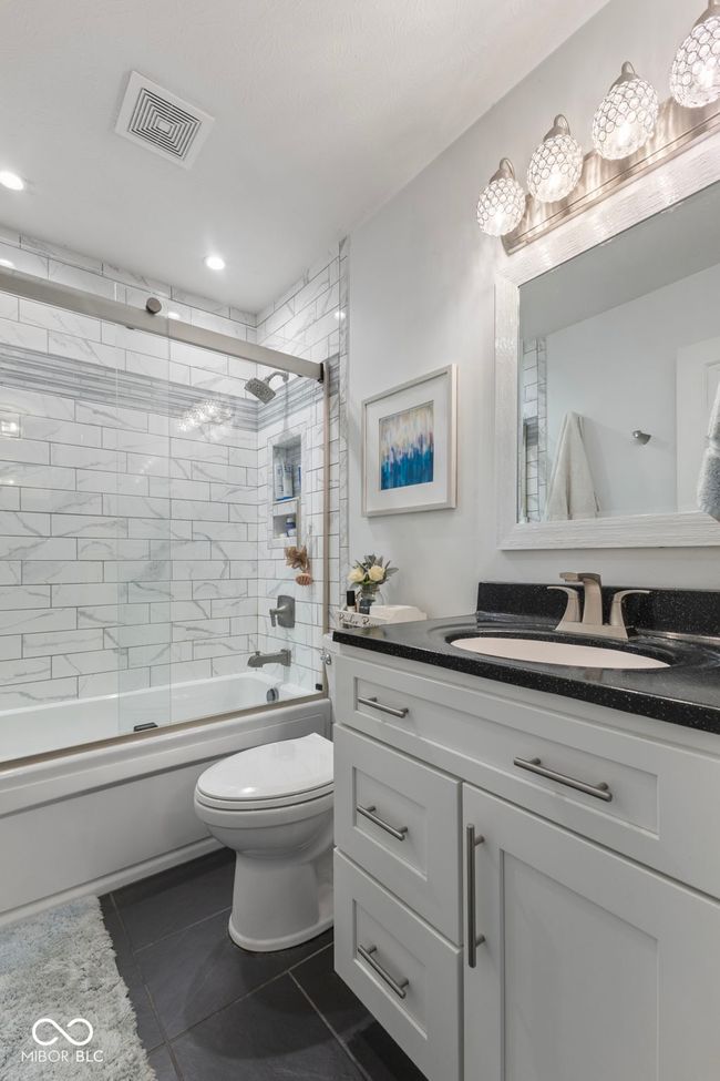 full bath featuring vanity, shower / bath combination with glass door, tile patterned floors, and recessed lighting | Image 19