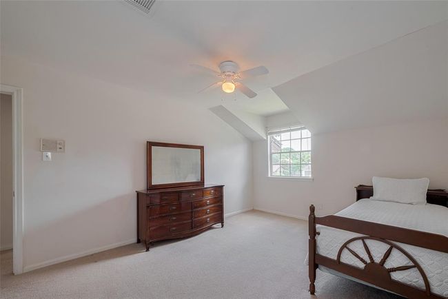 Cozy and bright, Bedroom 3 features a charming dormer window and ample space, perfect for relaxation or a guest retreat. | Image 24