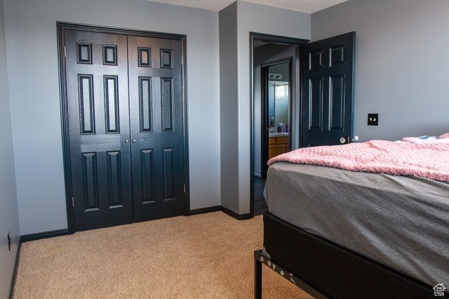 Bedroom featuring light carpet, baseboards, and a closet | Image 18