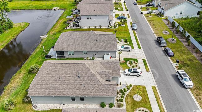 Aerial view of residential area featuring a large body of water | Image 10