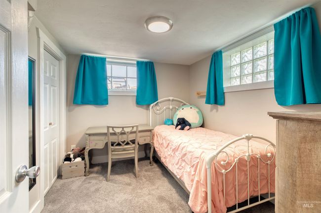 Carpeted bedroom with multiple windows | Image 30
