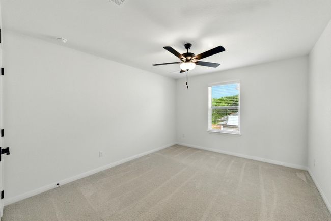 Unfurnished room with light carpet, a ceiling fan, and baseboards | Image 26