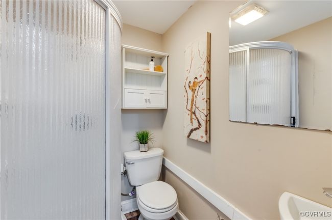 Bathroom with toilet, baseboards, and a shower stall | Image 27