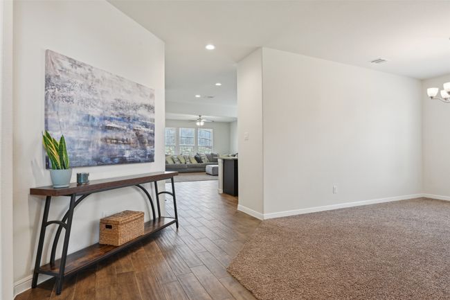 Hallway with a chandelier, recessed lighting, wood finished floors, and baseboards | Image 15