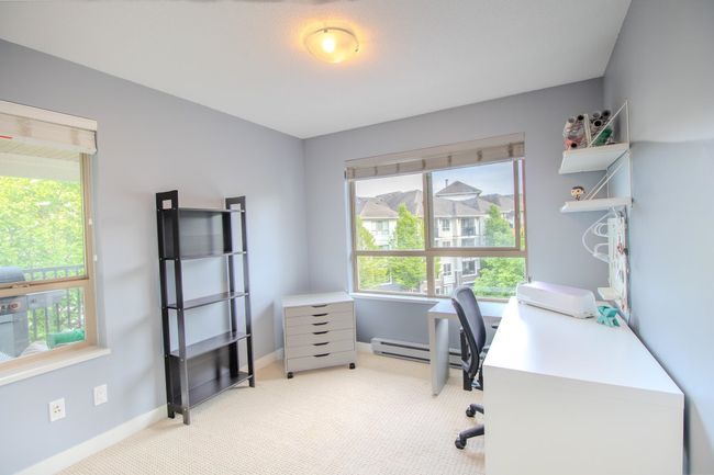 Office space featuring light colored carpet and a baseboard heating unit | Image 10