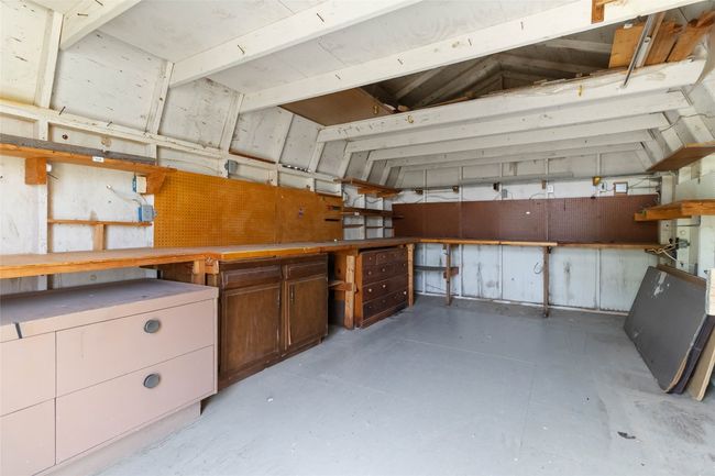 Garage featuring a workshop area | Image 24