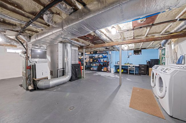 Basement with concrete block wall and independent washer and dryer | Image 36