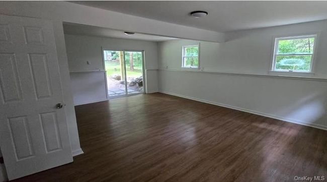 Empty room with dark wood finished floors and baseboards | Image 18