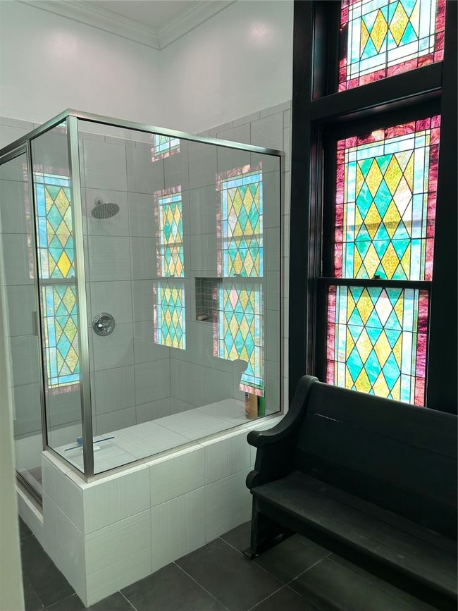 Bathroom featuring a stall shower, ornamental molding, and dark tile patterned floors | Image 15