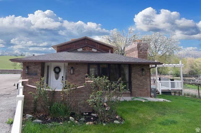 View of front of property with a chimney, a front yard, and brick siding | Image 31