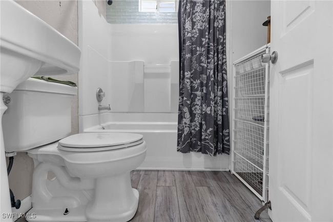 Full bathroom shower / tub combo with curtain, and toilet | Image 24