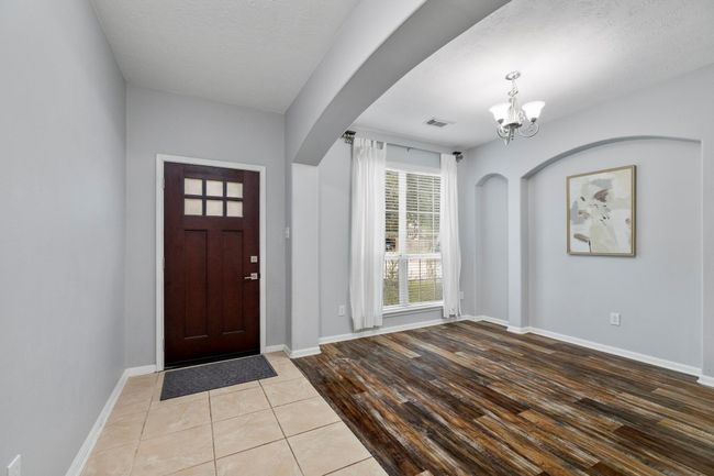 Tucked just off the foyer, the formal dining room features arched details and natural light—ready for hosting or repurposing to suit your needs. | Image 5