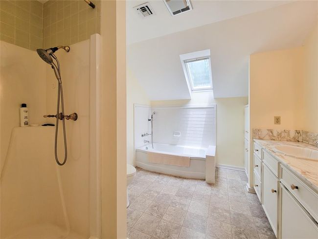 Spacious upstairs bathroom featuring a shower and a relaxing tub. | Image 27