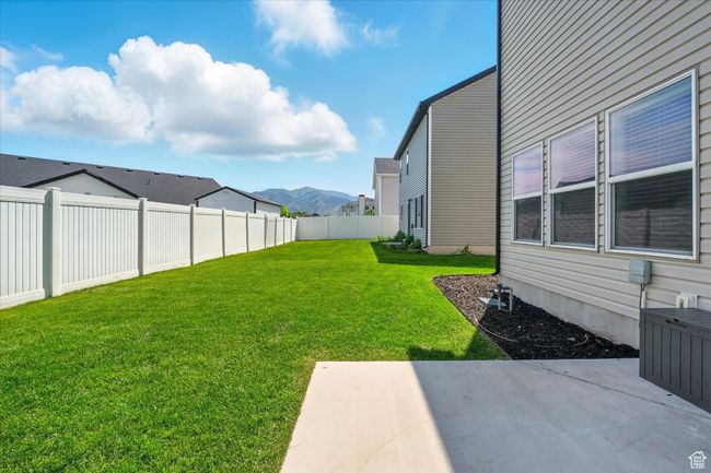 Fenced backyard featuring a patio and a mountain view | Image 24